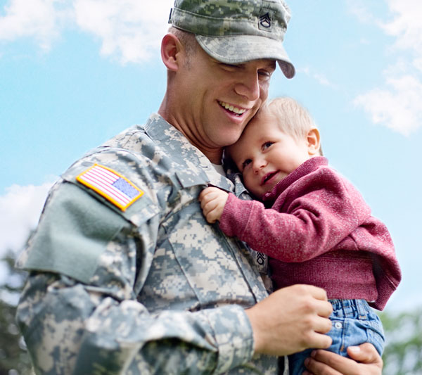 veteran carrying his son